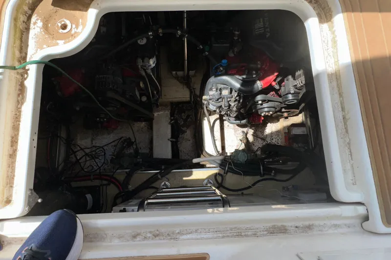 Slide: The Image of Engine compartment of a 2006 Larson Cabrio 350 boat, showing mechanical components and wiring. - 22