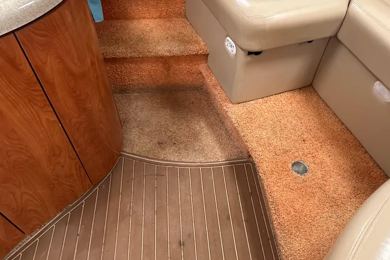 Slide: The Image of 2006 Larson Cabrio 350 interior with carpeted steps and wood paneling. - 23