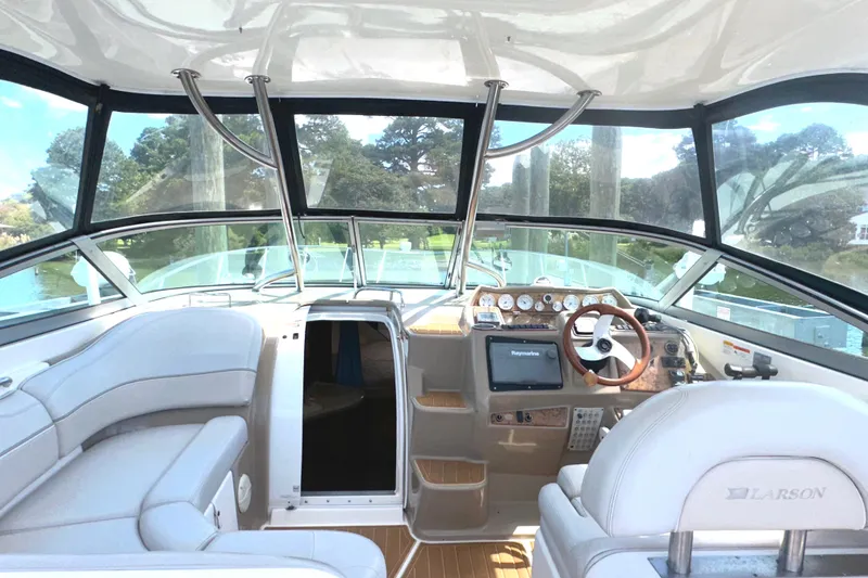 Slide: The Image of Interior of a 2006 Larson Cabrio 350 boat with modern dashboard and seating. - 30