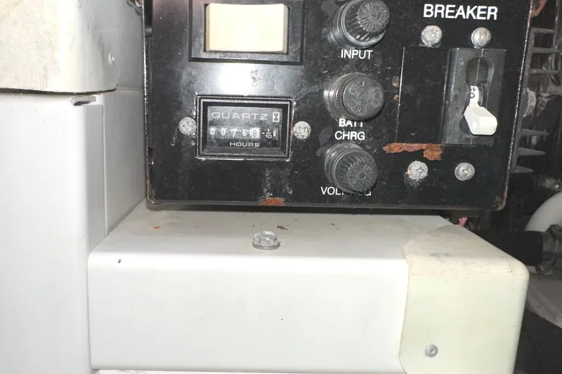 Slide: The Image of Control panel of a 2006 Larson Cabrio 350 boat with hour meter and breaker switches. - 34