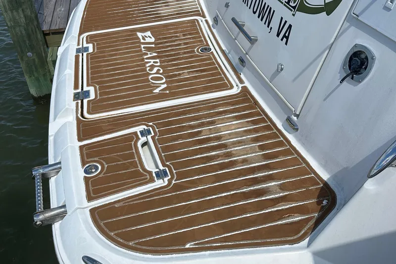 Slide: The Image of 2006 Larson Cabrio 350 boat deck with brown non-slip surface and logo. - 39