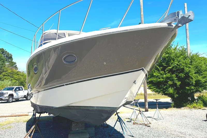 Slide: The Image of 2006 Larson Cabrio 350 boat on stands, sunny day, side view. - 7