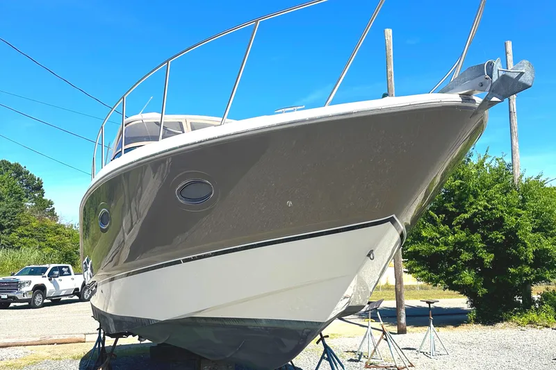 Slide: The Image of 2006 Larson Cabrio 350 boat on dry dock under clear blue sky. - 8
