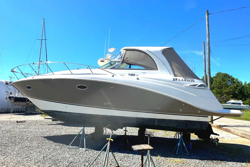 Slide: The Image of 2006 Larson Cabrio 350 boat on stands, clear sky background. - 9