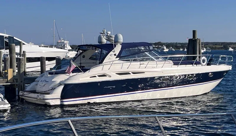 The Image of 2003 Cranchi 50 Mediterranne yacht docked in a marina, featuring sleek design and blue accents. - 0