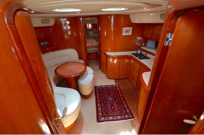 Slide: The Image of 2003 Cranchi 50 Mediterranne yacht interior with wood finish and cozy seating area. - 10
