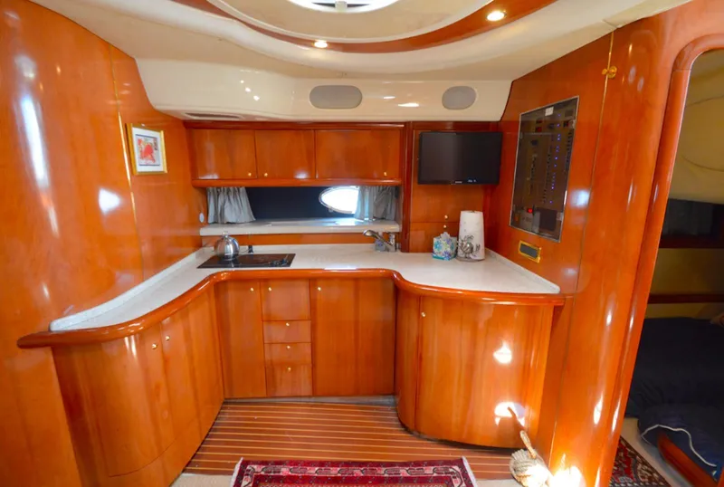 Slide: The Image of Luxurious wooden interior of 2003 Cranchi 50 Mediterranne yacht kitchen with modern amenities. - 11