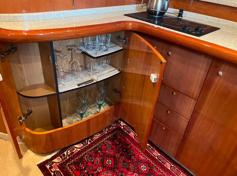 Slide: The Image of Interior of 2003 Cranchi 50 Mediterranne yacht with open cabinet and glassware. - 12