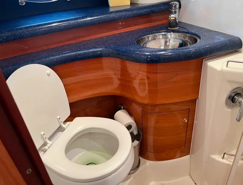 Slide: The Image of 2003 Cranchi 50 Mediterranne yacht bathroom with wooden cabinetry and blue countertop. - 15