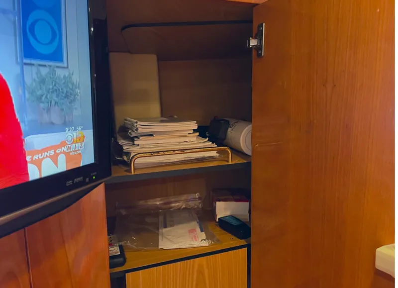 Slide: The Image of Open cabinet with papers and TV inside 2003 Cranchi 50 Mediterranne yacht interior. - 20