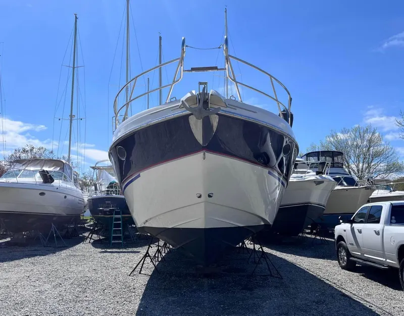 Slide: The Image of 2003 Cranchi 50 Mediterranne yacht on dry dock, surrounded by other boats and vehicles. - 4