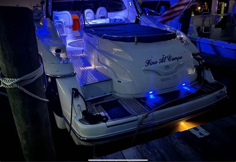 Slide: The Image of 2003 Cranchi 50 Mediterranne yacht docked at night with blue LED lights. - 7