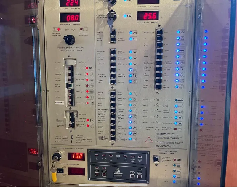 Slide: The Image of Control panel of a 2003 Cranchi 50 Mediterranne yacht, featuring switches and digital displays. - 9