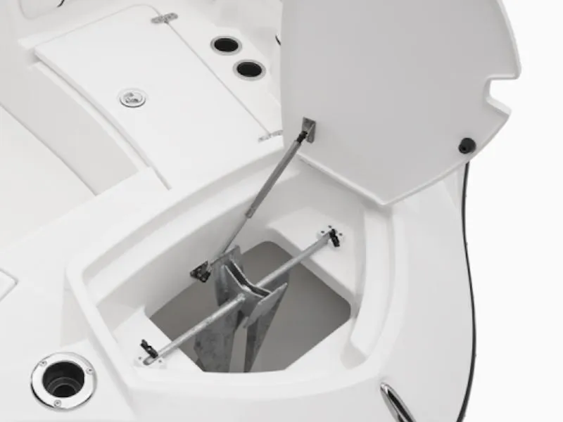 Slide: The Image of 2025 Yamaha Boats 220 FSH Sport anchor storage compartment, open lid, white interior. - 4