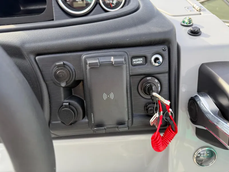 Slide: The Image of Control panel of 2025 South Bay S222CR2 boat with ignition key and power switches. - 10