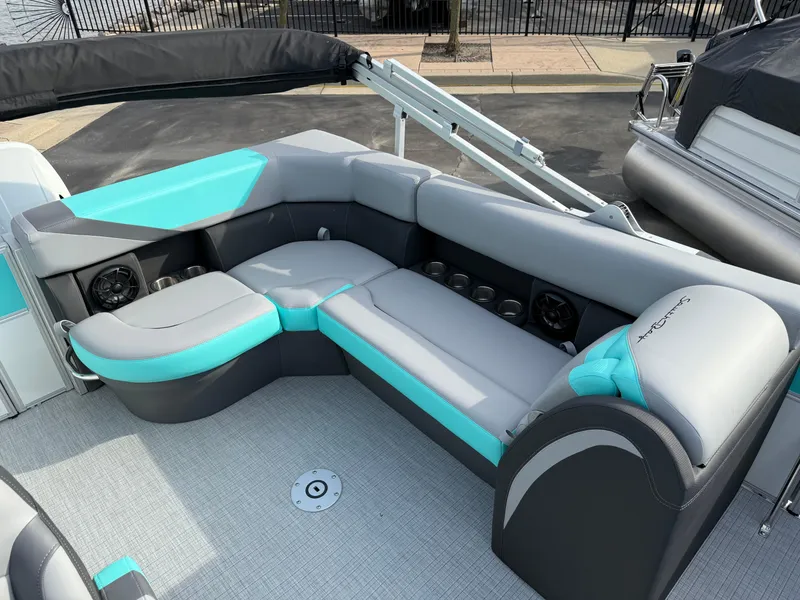 Slide: The Image of 2025 South Bay S222CR2 pontoon boat interior with gray and teal seating. - 13
