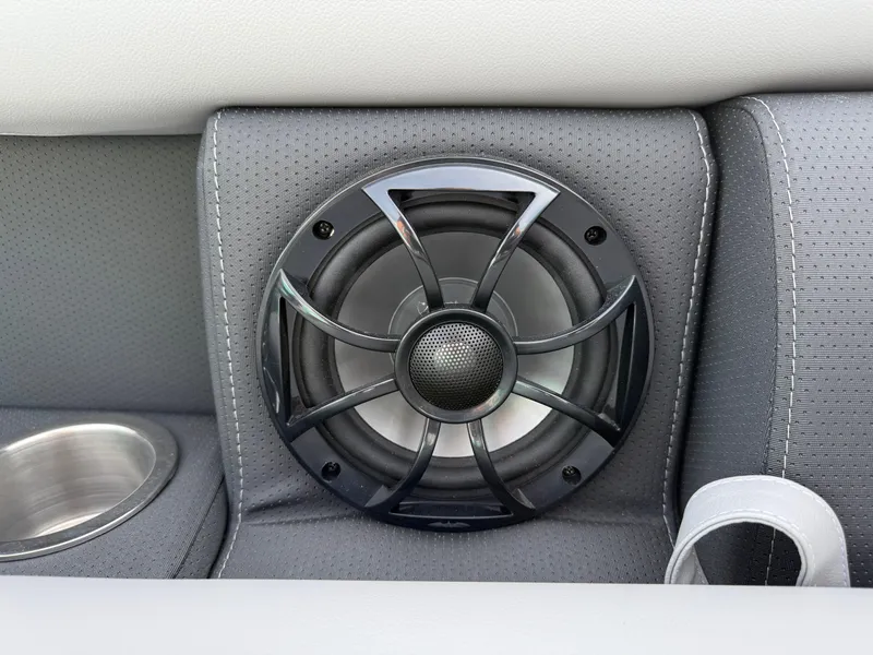 Slide: The Image of Speaker and cup holder on 2025 South Bay S222CR2 boat's gray interior. - 14