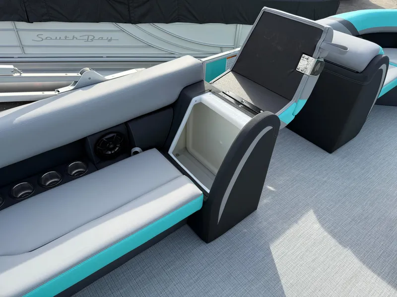 Slide: The Image of 2025 South Bay S222CR2 boat interior with open storage compartment and sleek seating design. - 16