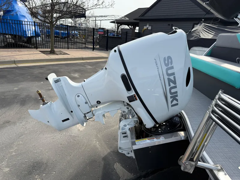Slide: The Image of 2025 South Bay S222CR2 boat with Suzuki outboard motor in a parking area. - 27