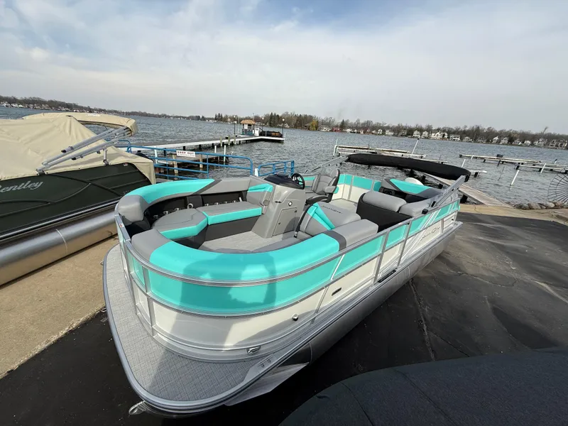 Slide: The Image of 2025 South Bay S222CR2 pontoon boat docked by a lake. - 30