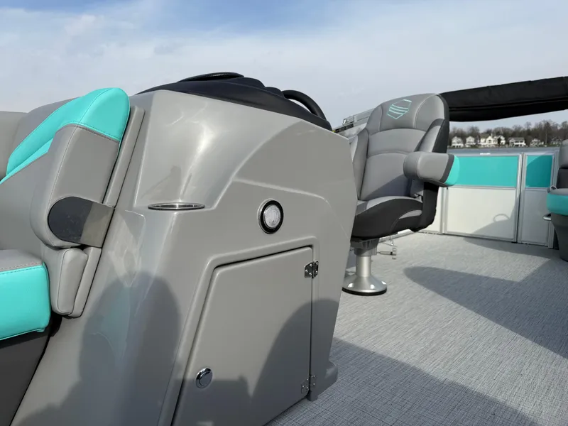 Slide: The Image of 2025 South Bay S222CR2 boat interior with gray and teal seating, modern design. - 6