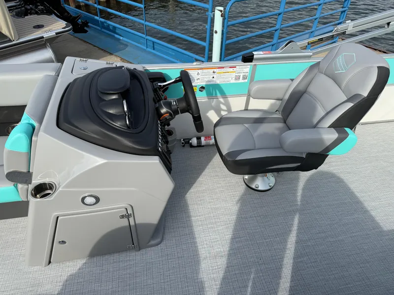 Slide: The Image of 2025 South Bay S222CR2 boat interior with steering console and captain's chair. - 7