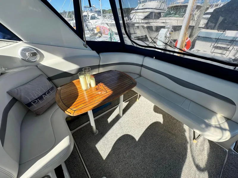 Slide: The Image of 2005 Chaparral Signature 350 interior with seating, table, and marina view. - 3