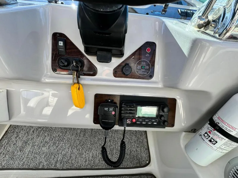 Slide: The Image of Control panel of 2005 Chaparral Signature 350 boat with radio and ignition keys. - 5
