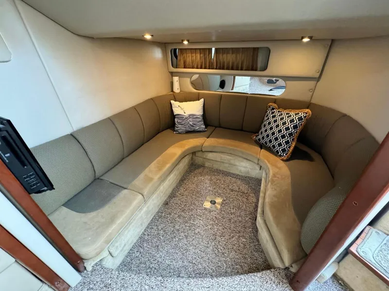 Slide: The Image of Interior of 2005 Chaparral Signature 350 yacht with cozy seating and decorative pillows. - 9