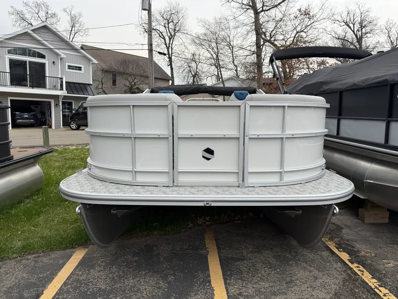 Slide: The Image of 2025 South Bay 220RS LE pontoon boat parked in a residential area. - 19