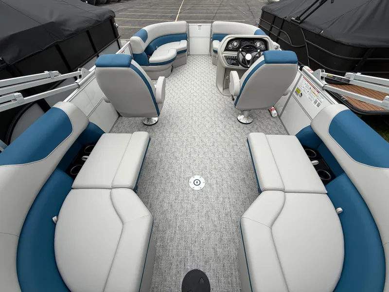 Slide: The Image of 2025 South Bay 220RS LE pontoon boat interior with plush seating and modern dashboard. - 23
