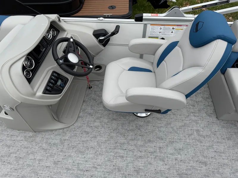 Slide: The Image of Captain's chair and helm of 2025 South Bay 220RS LE boat, featuring modern controls and upholstery. - 6
