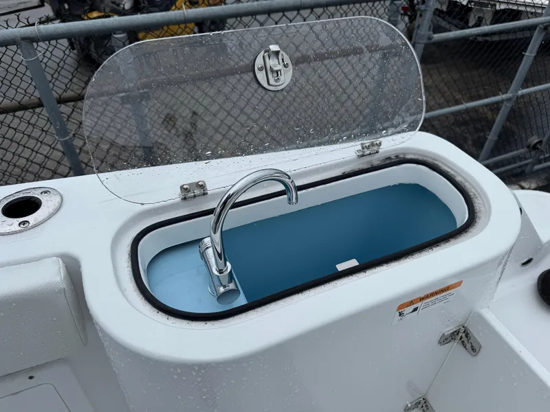 Slide: The Image of Livewell on 2025 Wellcraft 263 Fisherman boat, featuring a transparent lid and faucet. - 11