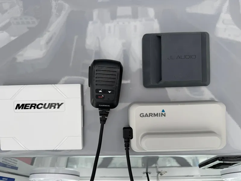 Slide: The Image of Mercury, Garmin, and JL Audio equipment on Wellcraft 263 Fisherman 2025 boat dashboard. - 21