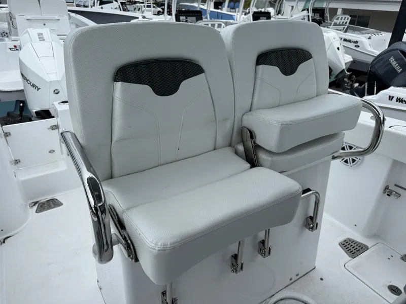 Slide: The Image of 2025 Wellcraft 263 Fisherman boat seats, white upholstery, modern design, dual seating arrangement. - 23