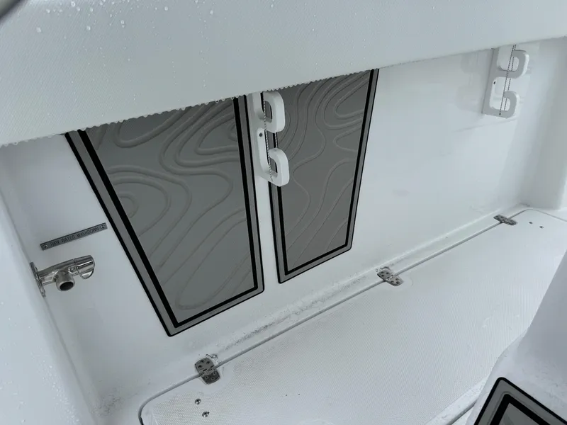 Slide: The Image of 2025 Wellcraft 263 Fisherman boat interior storage compartment with sleek design. - 24