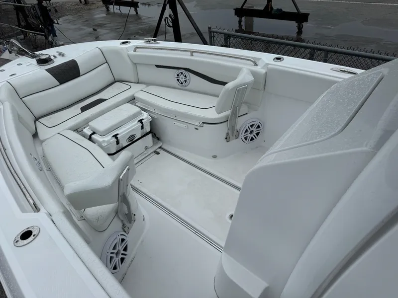 Slide: The Image of 2025 Wellcraft 263 Fisherman boat interior with white seating and storage compartments. - 27