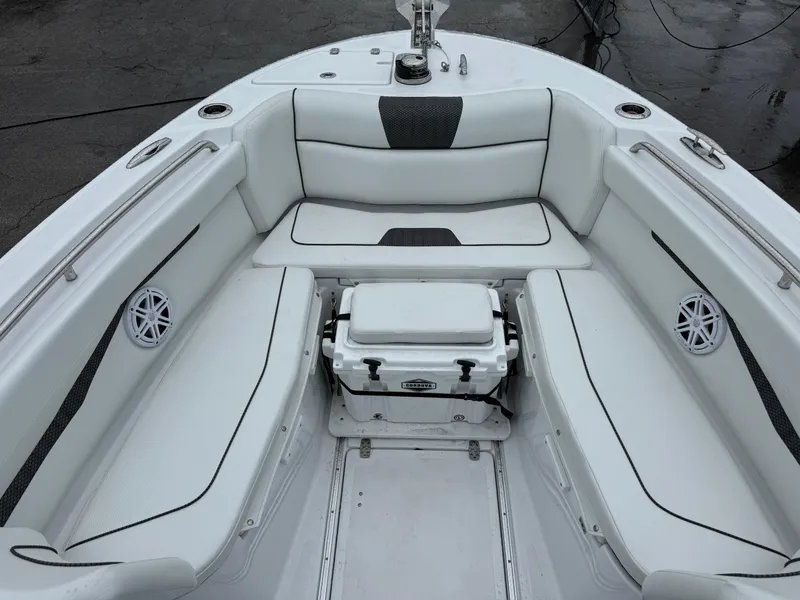 Slide: The Image of 2025 Wellcraft 263 Fisherman boat interior with white seating and cooler. - 29