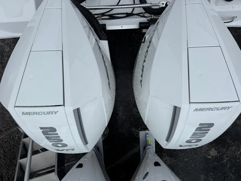 Slide: The Image of Twin Mercury outboard engines on a 2025 Wellcraft 263 Fisherman boat. - 3