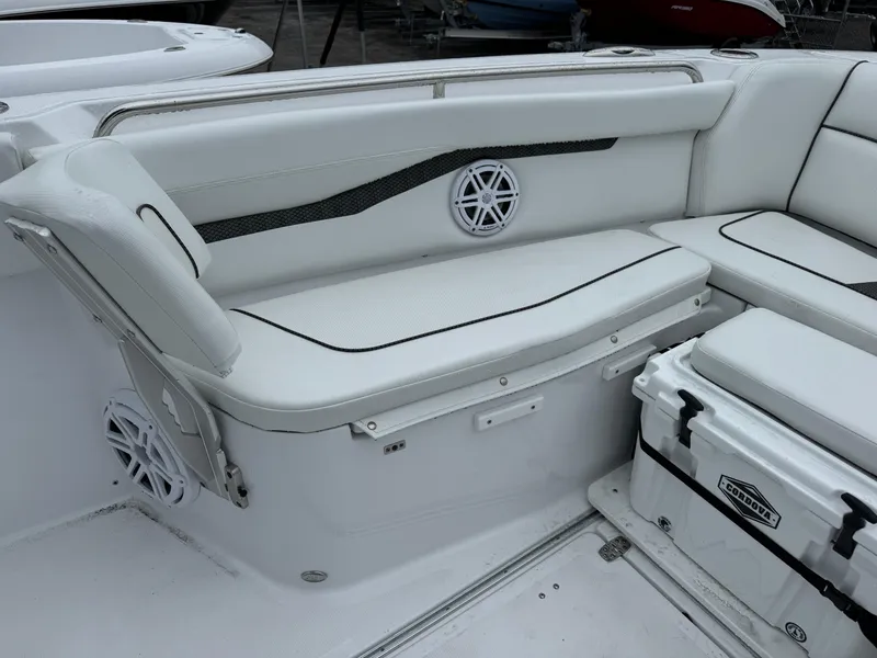 Slide: The Image of 2025 Wellcraft 263 Fisherman boat interior with white seating and storage. - 32