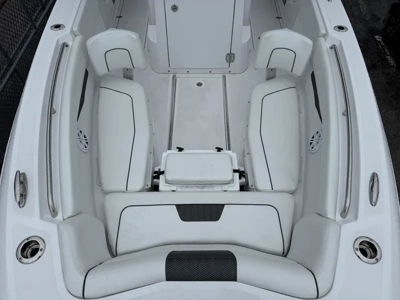 Slide: The Image of 2025 Wellcraft 263 Fisherman boat interior with white cushioned seating and storage compartments. - 34