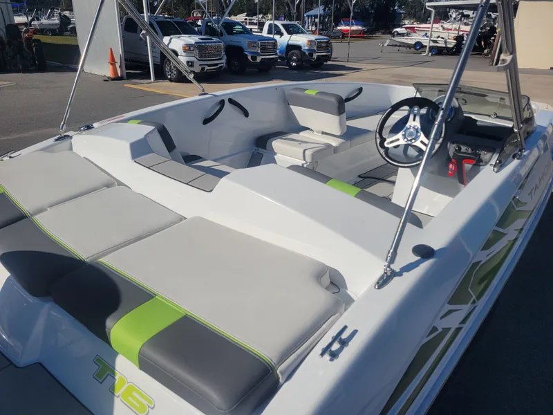 Slide: The Image of 2021 Tahoe T16 boat with modern seating and steering, displayed outdoors. - 5