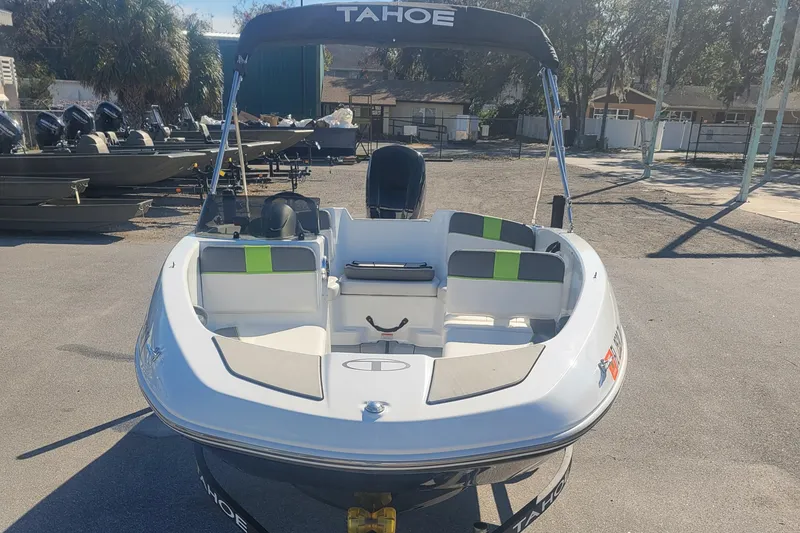 Slide: The Image of 2021 Tahoe T16 boat with seating, parked outdoors. - 8