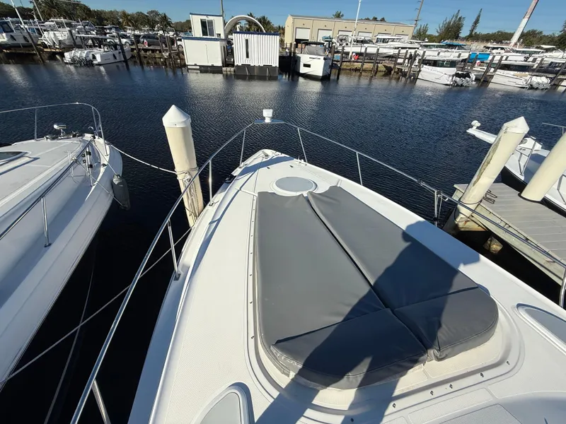 Slide: The Image of 2005 Cruisers Yachts 340 Express docked at marina, view of bow and water. - 14