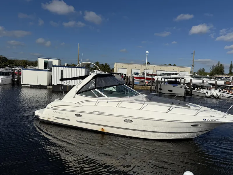 The Image of 2005 Cruisers Yachts 340 Express in marina, clear sky, calm water. - 0