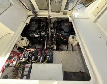 Slide: The Image of Engine compartment of 2005 Cruisers Yachts 340 Express, showing dual engines and wiring. - 28
