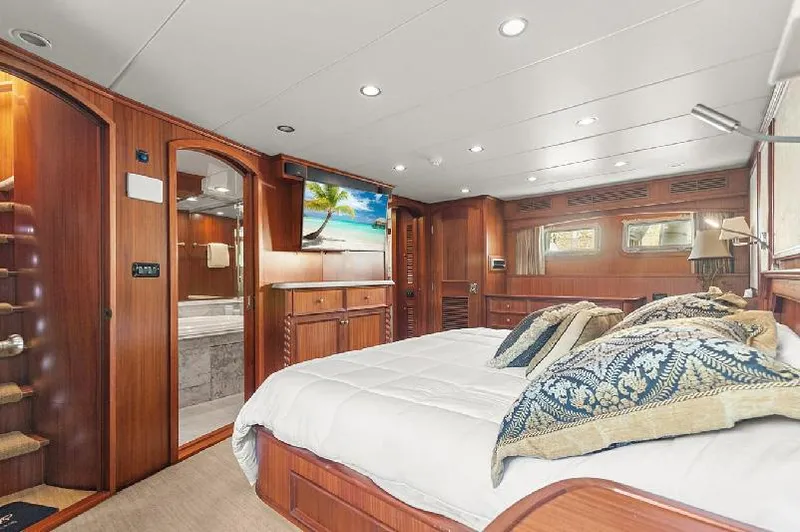 Slide: The Image of Luxurious 2006 Paragon Cockpit Motoryacht bedroom with elegant wood paneling and modern amenities. - 12