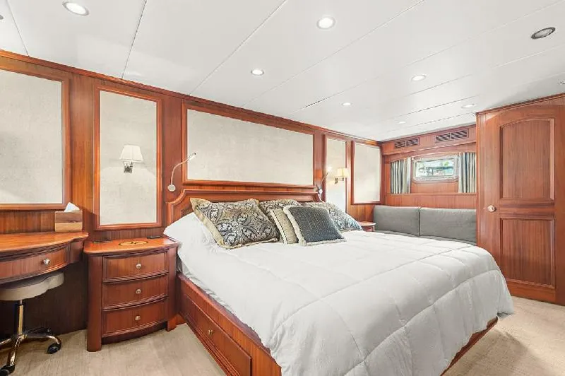 Slide: The Image of Luxurious bedroom in 2006 Paragon Cockpit Motoryacht with elegant wood paneling and plush bedding. - 13