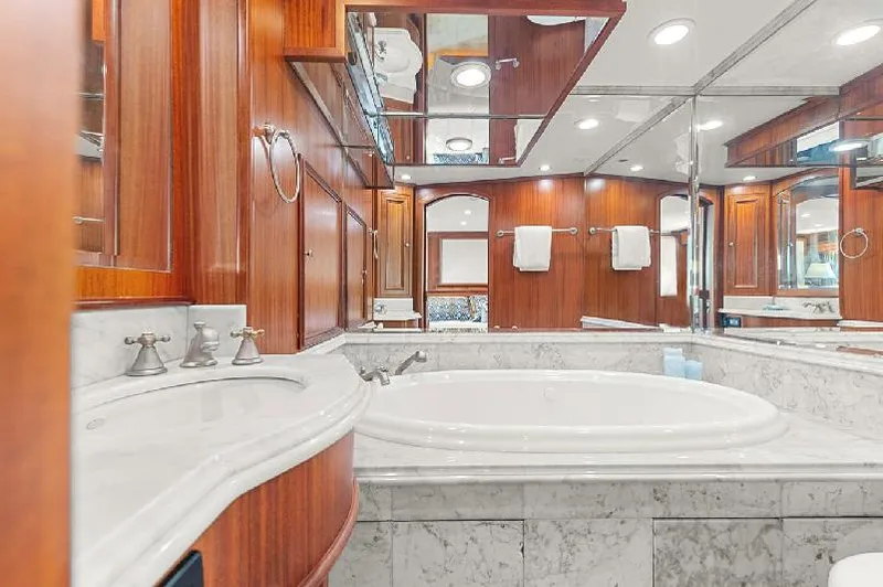 Slide: The Image of Luxurious bathroom in 2006 Paragon Cockpit Motoryacht with marble tub and wood paneling. - 14