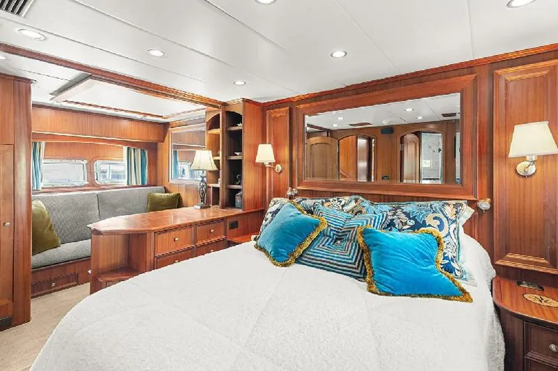 Slide: The Image of Luxurious 2006 Paragon Cockpit Motoryacht bedroom with elegant wood paneling and plush bedding. - 15